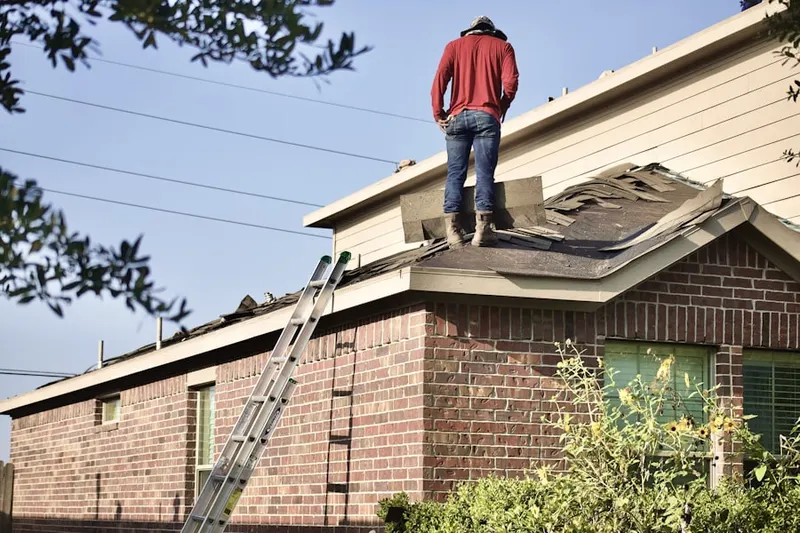 Professional roofer working on a residential roof in Huntington